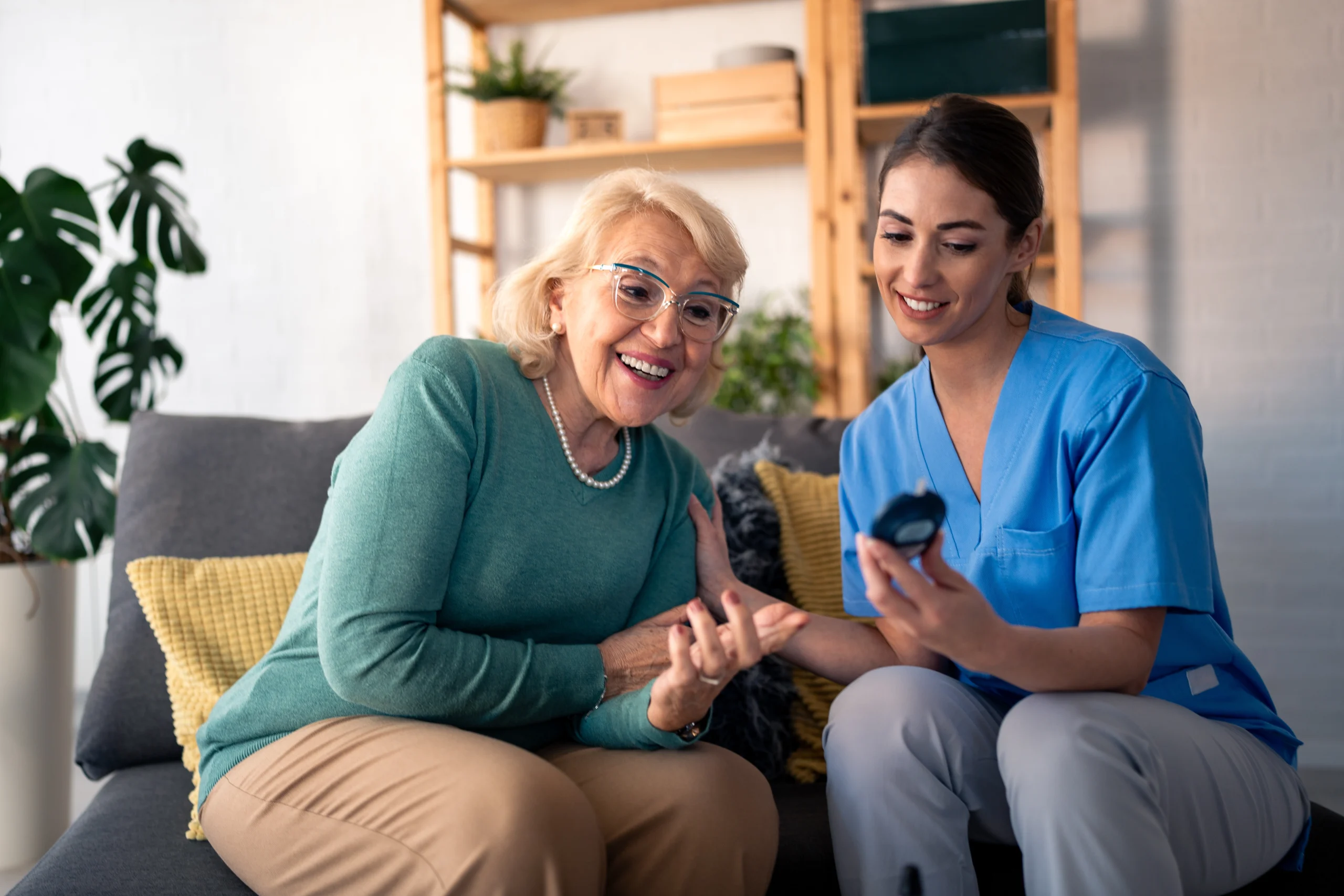Person seated looking at smartphone in preparation for a glucose test