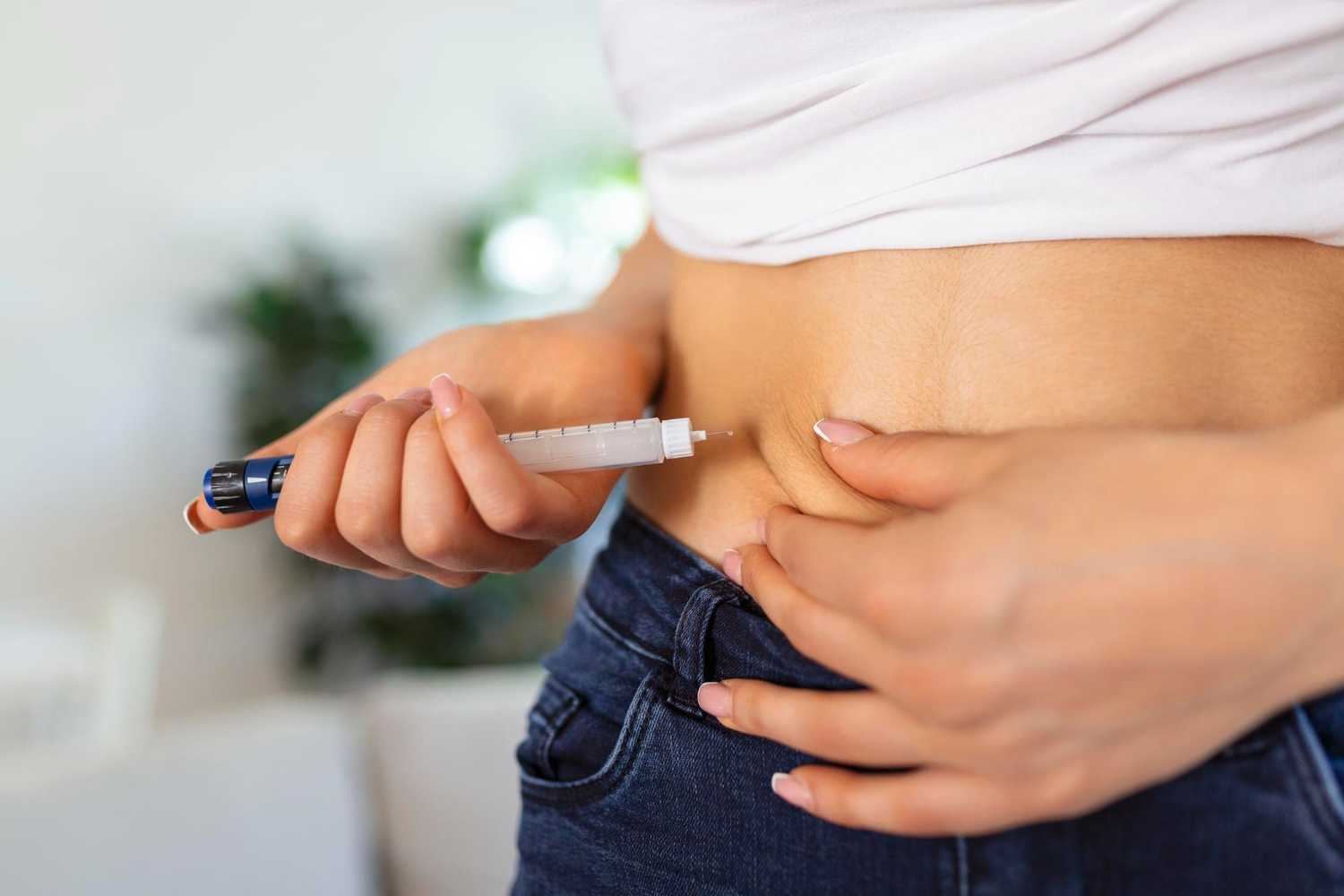 Person injecting Ozempic in the abdomen for weight loss and diabetes management 2025.